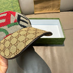 Gucci cap side view with beige GG canvas brim and multicolor embroidered top