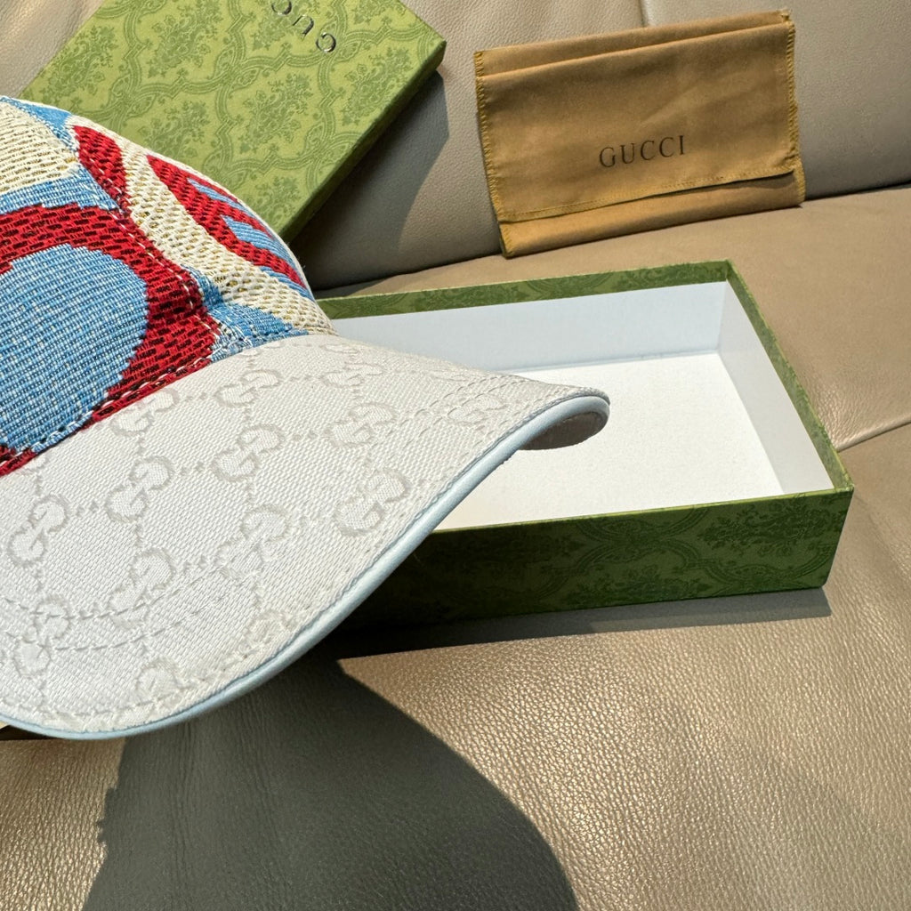 Gucci cap side close-up, white GG jacquard brim with blue-red knit crown