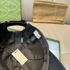 Black Gucci baseball cap with adjustable strap and interior size label.