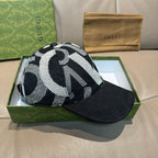 Black Gucci baseball cap with oversized black-and-white monogram jacquard crown.