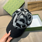 Black Gucci baseball cap with bold black-and-white GG monogram knit crown.
