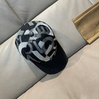 Black Gucci baseball cap with large black-and-white monogram jacquard front panel.