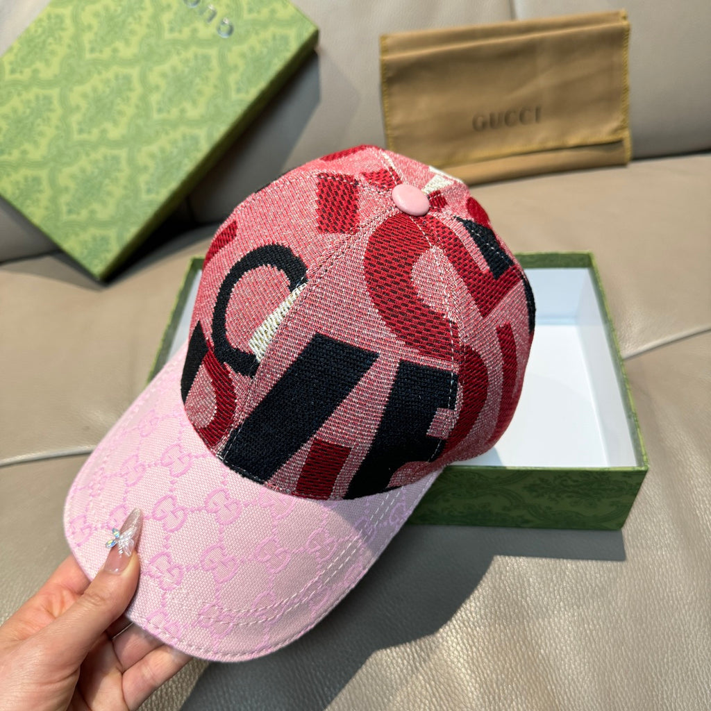 Pink baseball cap with red and black graphic crown and light pink GG-print brim