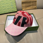 Pink baseball cap with red, black, and white patterned crown and brim