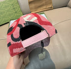 Baseball cap with patterned crown and pink leather-look strap, open side view