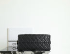 Black quilted Chanel bag with flap front and structured rectangular shape