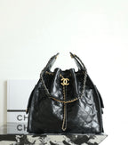 Black Chanel bag with quilted leather, braided chain shoulder strap, and gold CC emblem