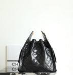 Black Chanel bag with quilted leather diamonds and braided chain top handles