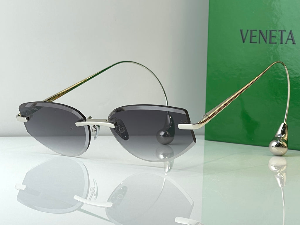 Glasses with light metal frames and dark tinted lenses