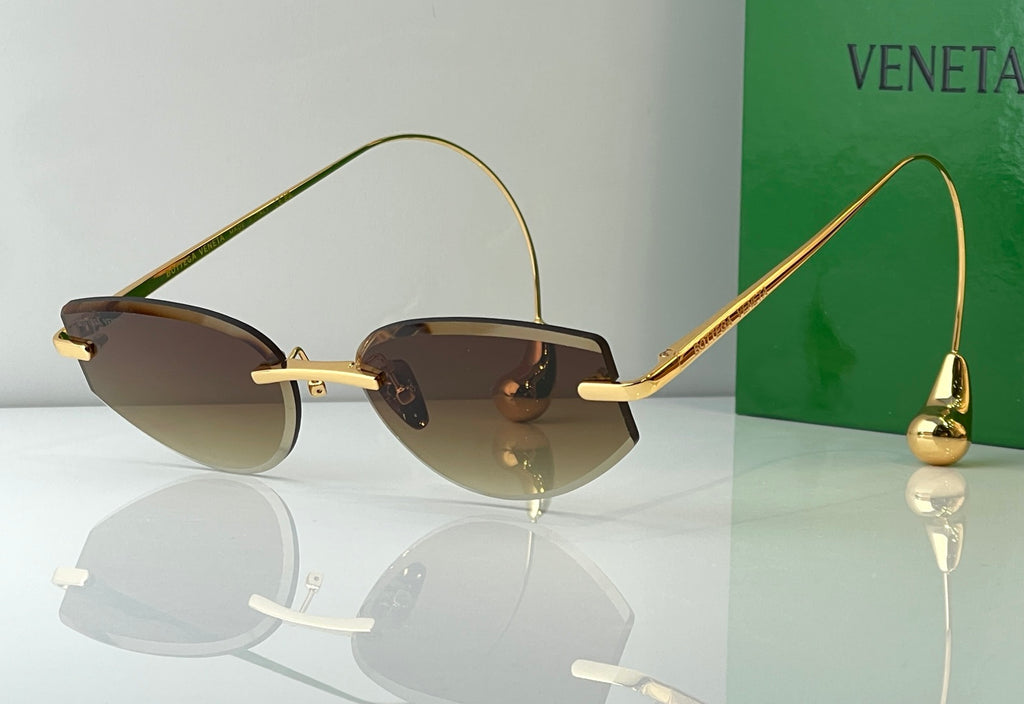 Glasses with gold metal frames and smoky gray tinted lenses