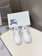 White low-top sneakers with blue horse logo on tongue and front lace area