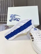 White low-top sneakers with blue patterned outsole and check-pattern side panel