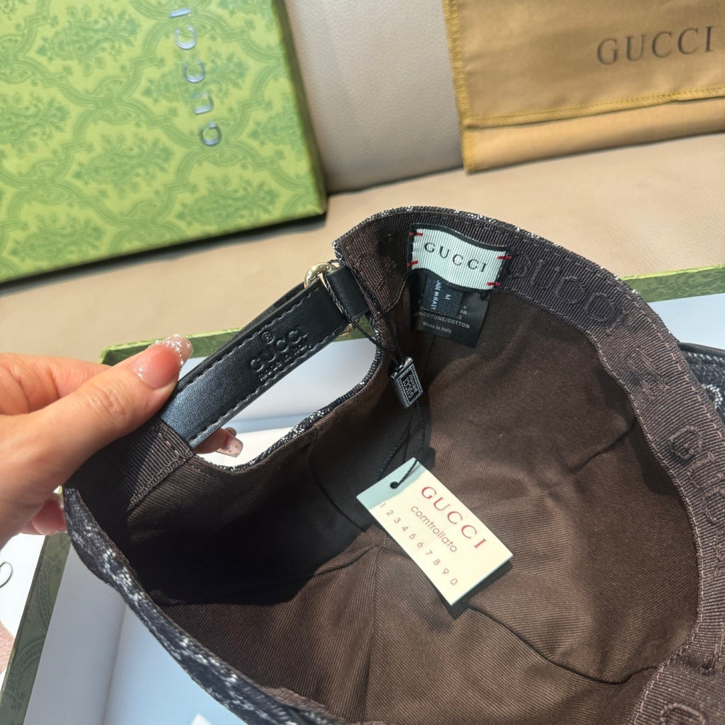 Black GG-style monogram baseball cap interior with leather-like trim and brand tags.