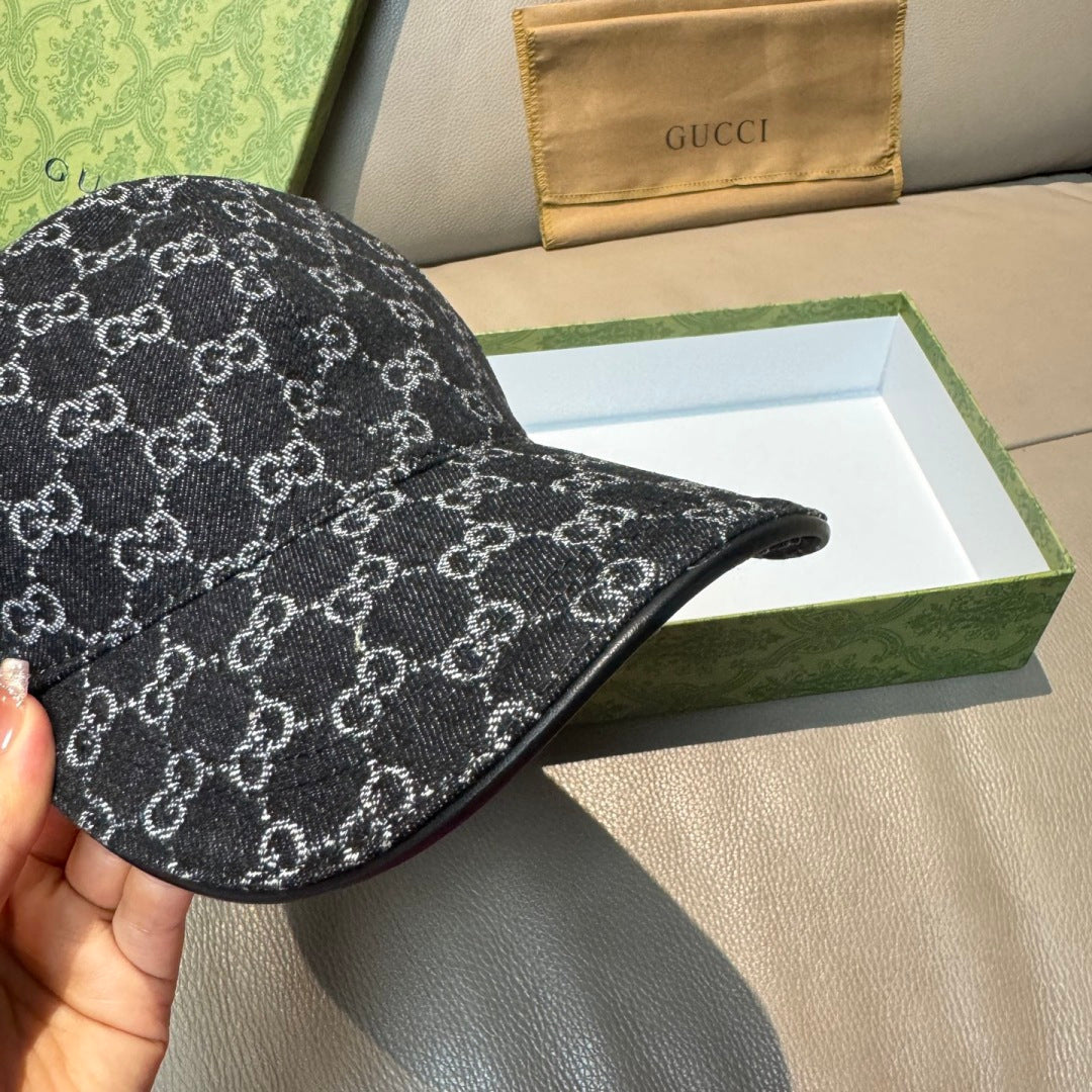 Black GG-style monogram baseball cap, front-left angle showing brim stitching.