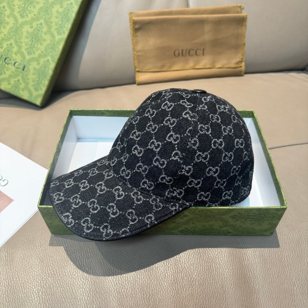 Black baseball cap with repeating GG-style monogram pattern and small top button.