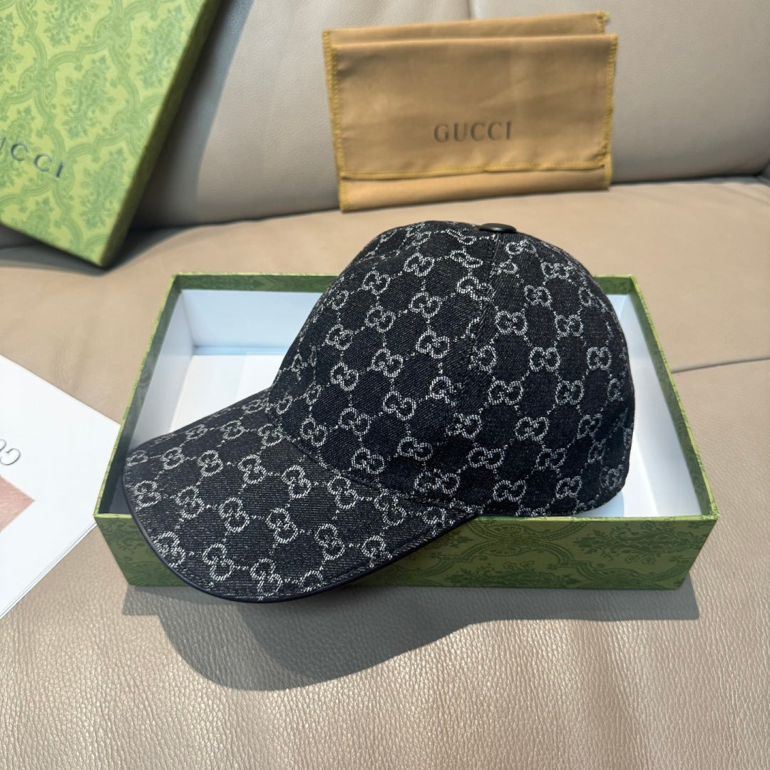Black baseball cap with repeating GG-style monogram pattern and small top button.