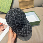Black GG-style monogram baseball cap, angled side view with curved brim.