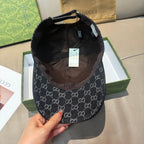 Inside view of a black GG-style monogram baseball cap with fabric lining and tags.