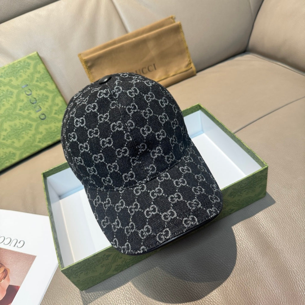 Black patterned baseball cap with repeating GG-style monograms and curved brim.