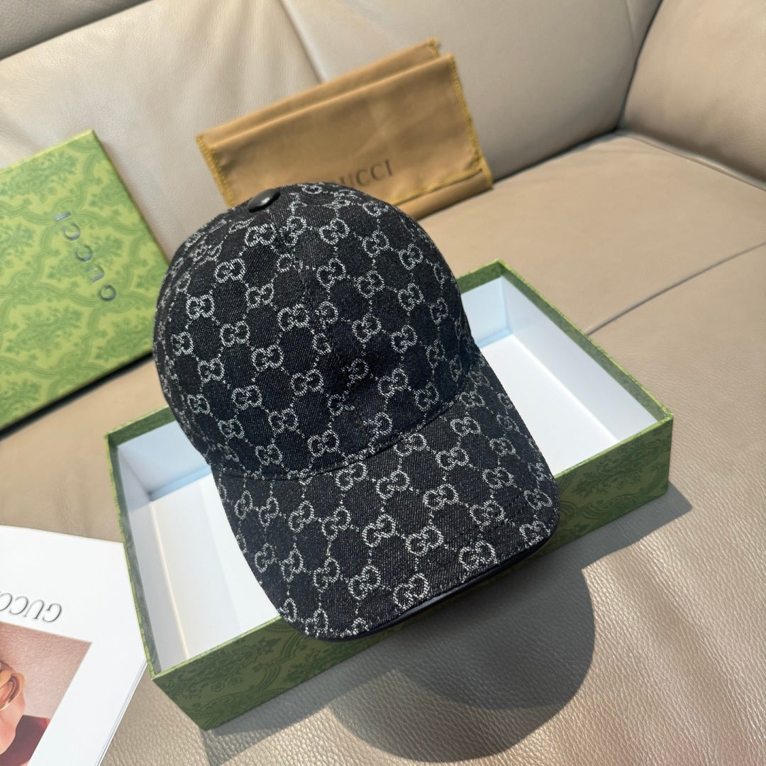 Black patterned baseball cap with repeating GG-style monograms and curved brim.