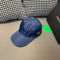 Prada baseball cap in blue with curved brim and stitched crown seams.