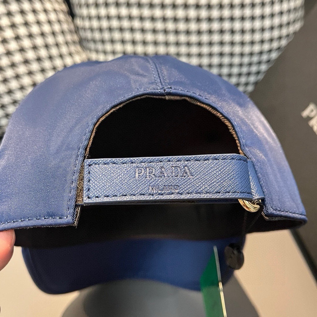Prada blue baseball cap opening with dark interior and PRADA label band.