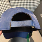 Prada blue baseball cap opening with dark interior and PRADA label band.