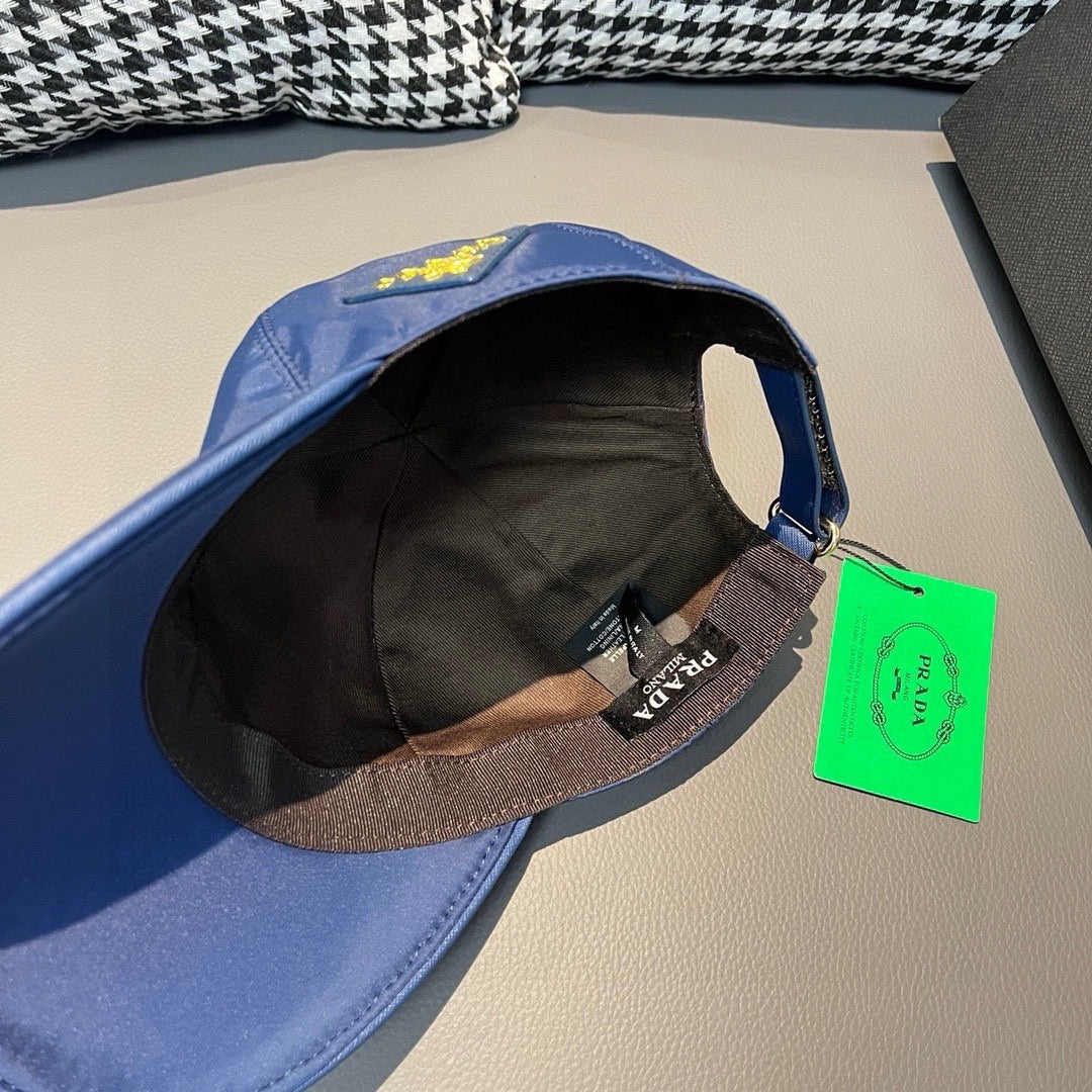 Prada blue baseball cap interior with black lining and adjustable strap.