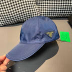 Prada blue baseball cap with PRADA logo patch on the front.