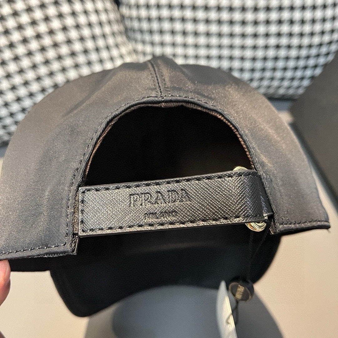 Black satin baseball cap interior with PRADA-printed strap