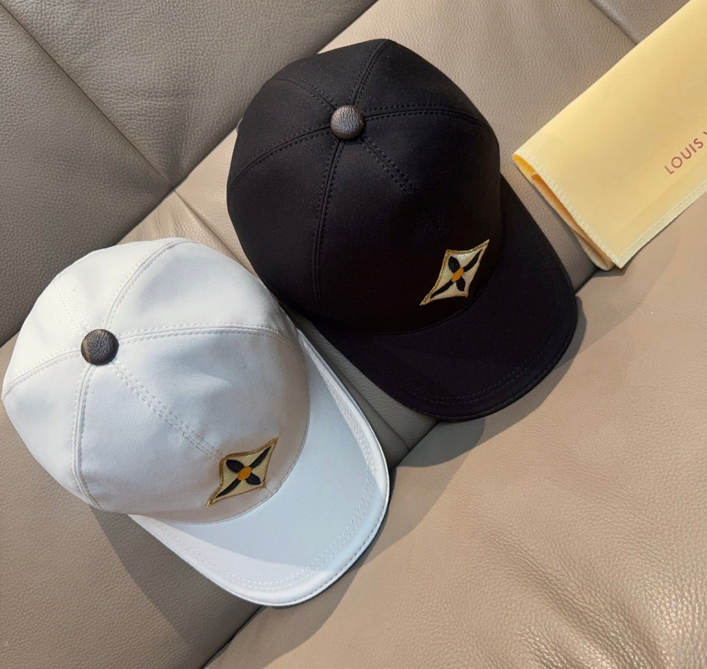 Set of Louis Vuitton caps: black and white, each with embroidered star logo.