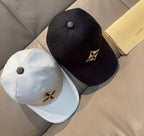 Set of Louis Vuitton caps: black and white, each with embroidered star logo.