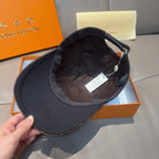 Black Louis Vuitton cap interior view with dark lining and small hanging tag.