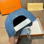 Blue denim cap opening with white interior strap label and hanging tag