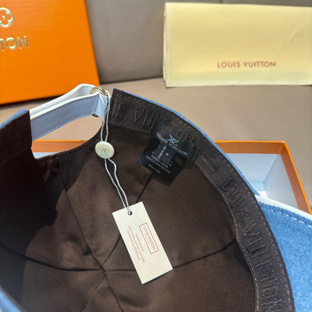 Blue denim cap interior with adjustable strap, lining detail, hanging tags