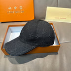 Black denim baseball cap with textured monogram pattern and curved brim, side view