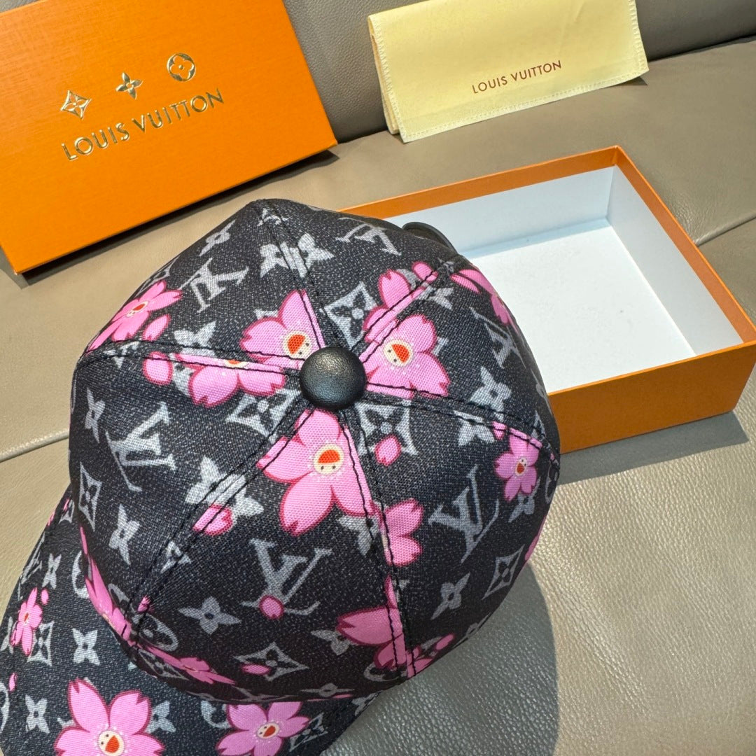 Louis Vuitton cap front panel close-up, dark monogram with bright pink flowers