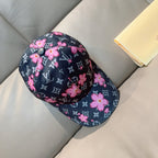 Louis Vuitton cap with pink flowers over dark monogram pattern and round front button