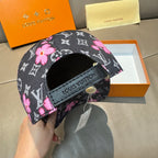 Louis Vuitton cap with black strap patch on front, pink floral and monogram pattern