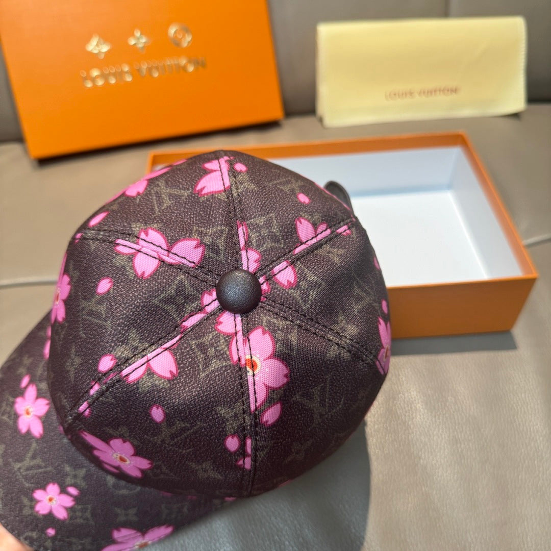 Louis Vuitton cap close-up, dark crown with pink flowers and center button