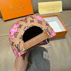Brown monogram baseball cap with pink floral print and tan strap on brim