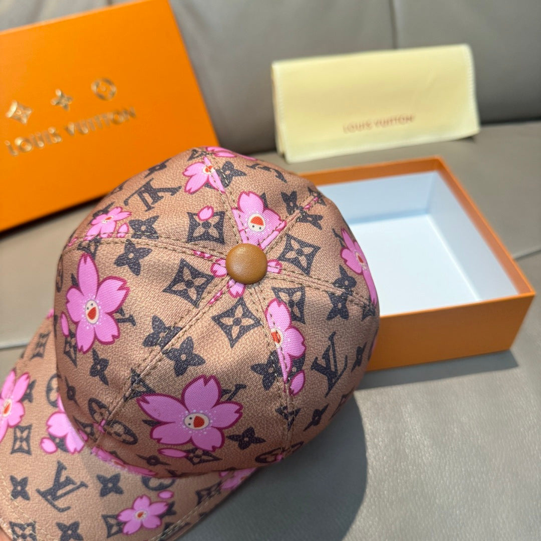 Brown monogram baseball cap with pink floral print and tan button on crown