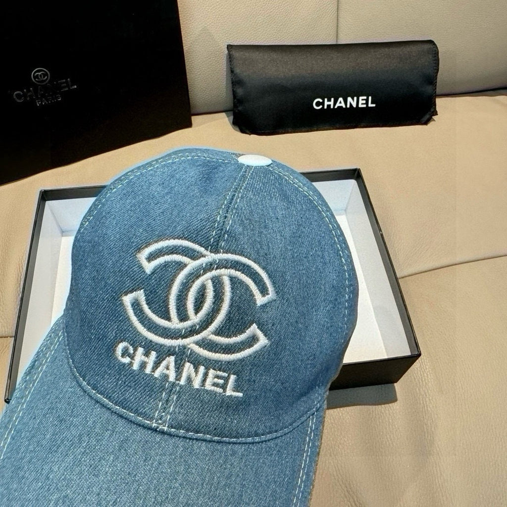 Denim baseball cap close-up with CHANEL logo embroidery, light blue, curved brim