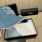 Denim baseball cap side view with CHANEL logo, curved brim, stitched edging