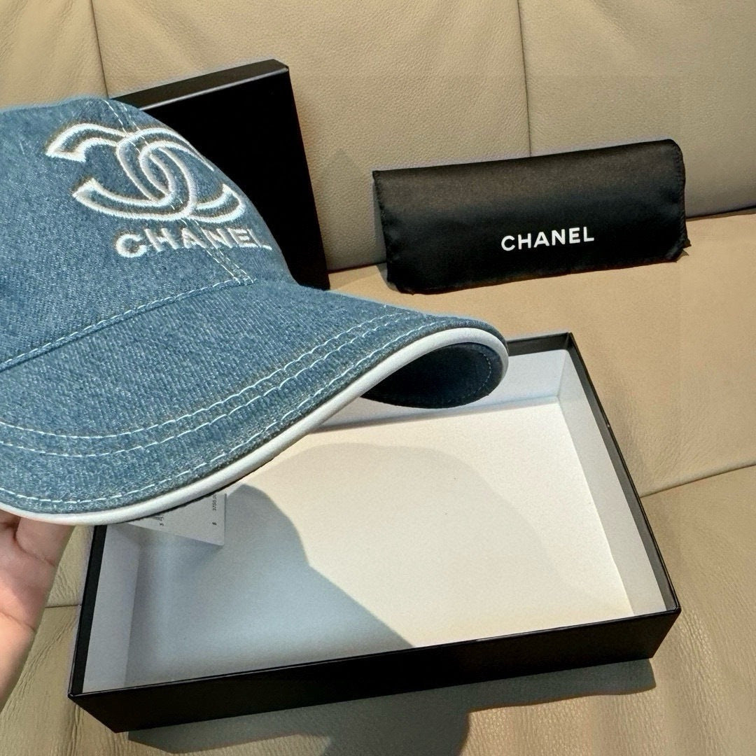 Denim baseball cap side view with CHANEL logo, curved brim, stitched edging