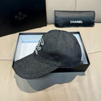 Dark charcoal denim baseball cap in box, white logo detail on front
