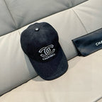 Black denim baseball cap with raised top button and white Chanel logo on front