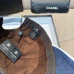 Denim baseball cap interior with brown lining and Chanel brand tags attached.