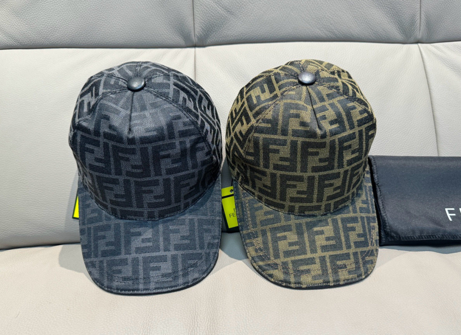 Two baseball caps with FF logo pattern in dark gray tones, curved brims