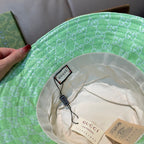 Gucci green monogram bucket hat interior with tags and cream lining